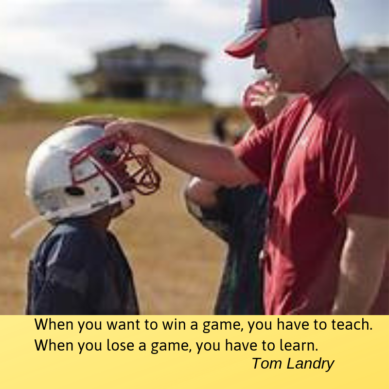 A man and a boy with football helmets.