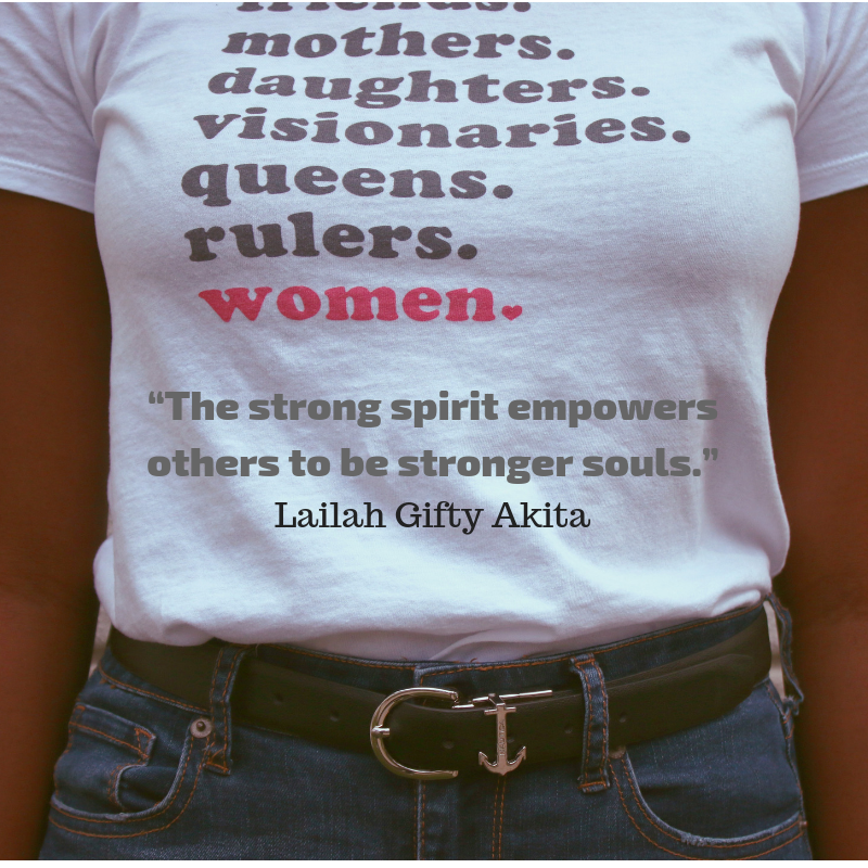 A woman wearing a white shirt with words on it.